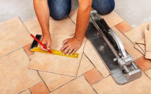 Measuring the area for porcelain tiles installation: professional using a tape measure to calculate the quantity of tiles needed for precise coverage